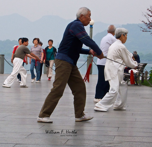 Early morning walkers and Tia Chi on West Lake